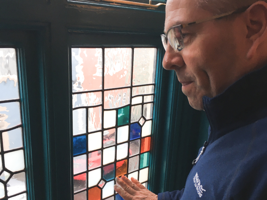 Man looking through stained glass window